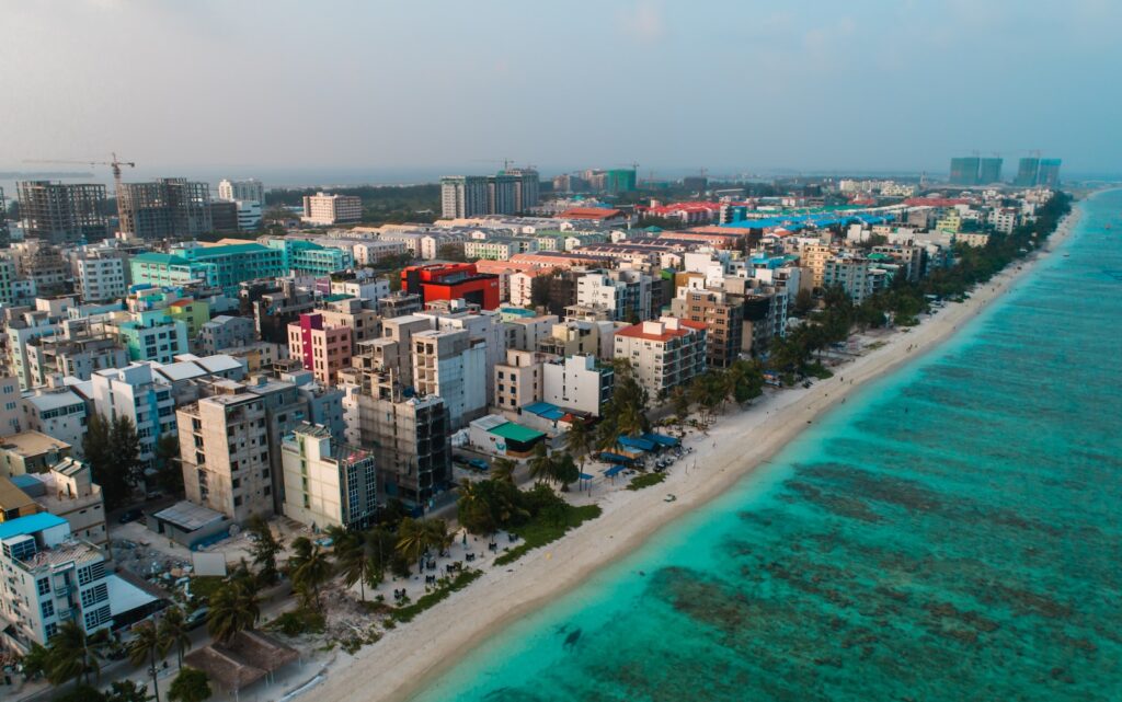 aerial view of city buildings near body of water during daytime